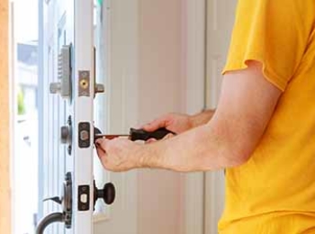 Worker installing or repairing new lock handyman repair the door lock