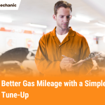 Auto mechanic writing notes during car tune-up to improve fuel efficiency and gas mileage at Need Mechanic shop