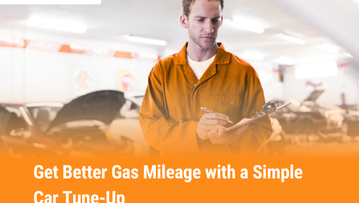 Auto mechanic writing notes during car tune-up to improve fuel efficiency and gas mileage at Need Mechanic shop