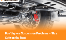 Close-up of car suspension problem showing damaged parts under vehicle with safety warning