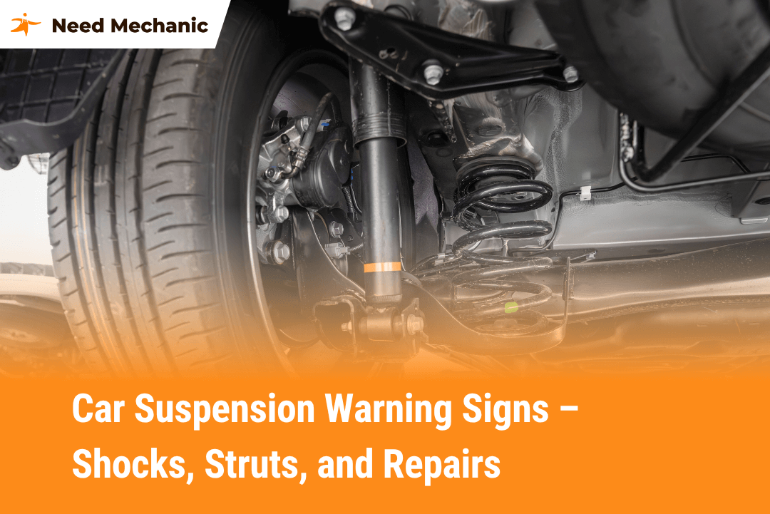 Close-up of car suspension system showing shocks and struts with Need Mechanic branding – helps diagnose signs of suspension problems