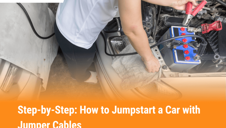 Person connecting red jumper cable to car battery terminal while jumpstarting a vehicle, showing safe and proper jumper cable use