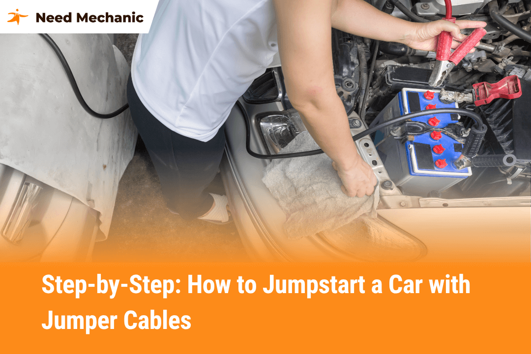 Person connecting red jumper cable to car battery terminal while jumpstarting a vehicle, showing safe and proper jumper cable use
