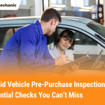 Mechanic and car buyer reviewing a hybrid vehicle pre‑purchase inspection checklist in a garage