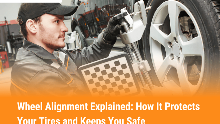 Car undergoing wheel alignment with calibration tool attached to front tire on a lift in an auto repair shop