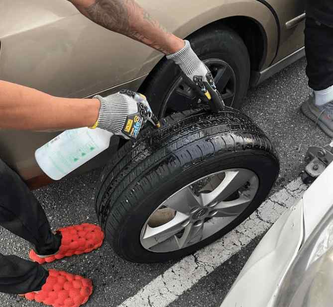 Leak in a Tire - Worker working on tire leak