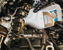 hand-pouring-oil-to-engine-13065699