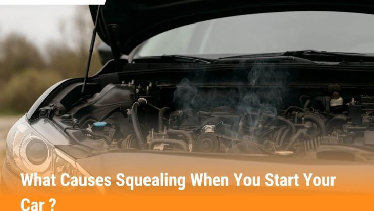 Car engine with hood open showing belts and pulleys, common cause of squealing noise when starting a car
