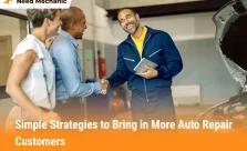 Mechanic shaking hands with customers in an auto repair shop, showing trust and customer growth strategies.