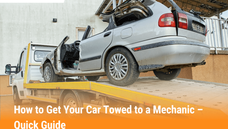 Tow truck loading a damaged car onto a flatbed, showing how to get your car towed to a mechanic safely and quickly.