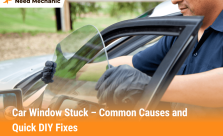 Mechanic repairing a stuck car window by adjusting the glass to fix common issues like motor, regulator, or track problems.