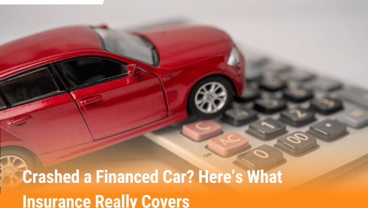 Red toy car crashed on a calculator symbolizing what happens if you crash a financed car with insurance and how payouts work.