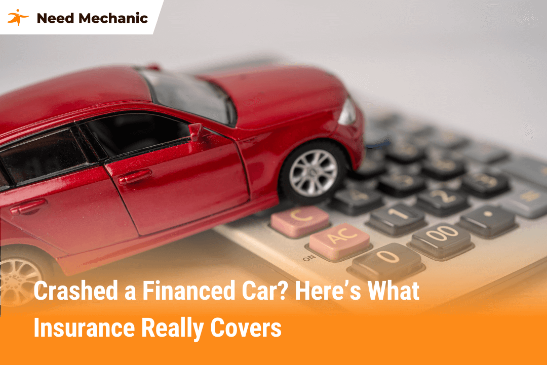 Red toy car crashed on a calculator symbolizing what happens if you crash a financed car with insurance and how payouts work.
