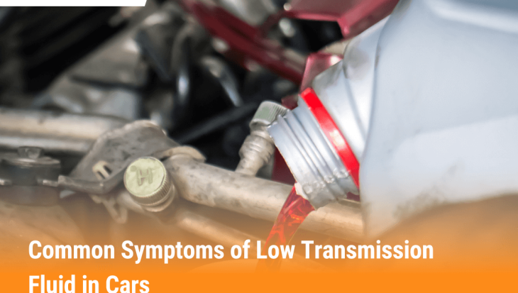 Mechanic pouring red transmission fluid into car engine to prevent low fluid symptoms