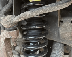 Mechanic repairing car suspension (5)