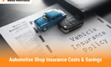 Miniature blue car and car key placed on a vehicle insurance policy document, symbolizing automotive shop insurance costs and savings.