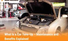 Car in a garage with hood open during tune-up maintenance